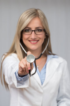 A Female Doctor With A Stethoscope Listening
