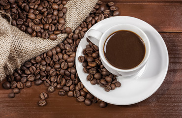 Coffee cup and jute sack full of coffee beans