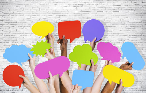 Group of Human Arms Raised with Speech Bubbles
