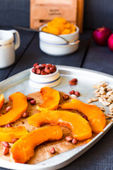 slices of baked pumpkin with honey, cinnamon and nuts