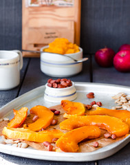 slices of baked pumpkin with honey, cinnamon and nuts