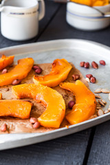 slices of baked pumpkin with honey, cinnamon and nuts