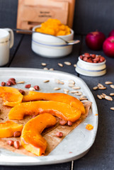 slices of baked pumpkin with honey, cinnamon and nuts