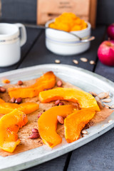 baked pumpkin slices with cinnamon and honey on parchment