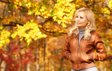 Fototapeta na wymiar Autumn Woman. Fall. Blonde Girl with Yellow Leaves