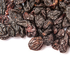 Black raisin over white background