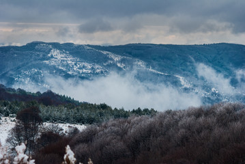 Fantastic evening winter landscape. Dramatic overcast sky