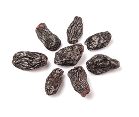 Black raisin over white background 