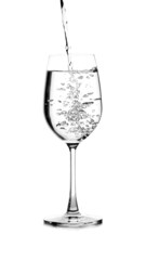 pouring water on a glass on white background