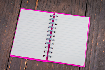 Note book on wooden background