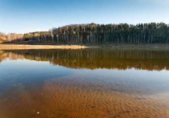 autumn trees reflected in the water of  lake