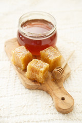 Jar of honey with honeycomb