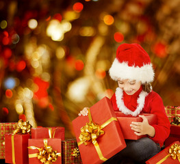Fototapeta na wymiar Christmas Kid Opening Present Gift Box, Happy Child in Santa Hat