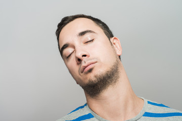 Fototapeta premium standing young tired man yawning and stretching