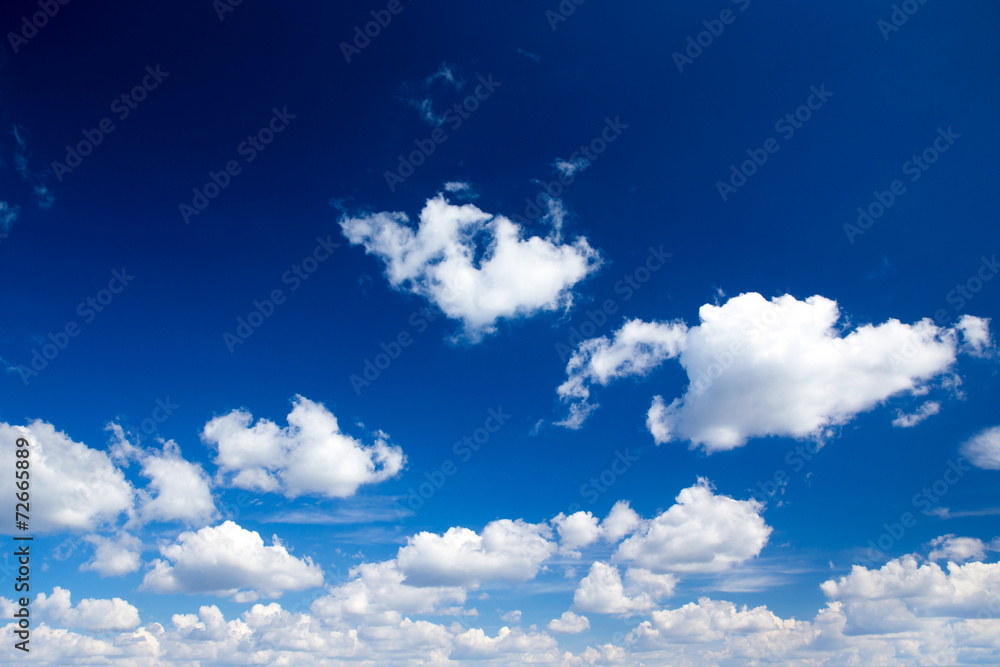 Wall mural blue sky background with tiny clouds