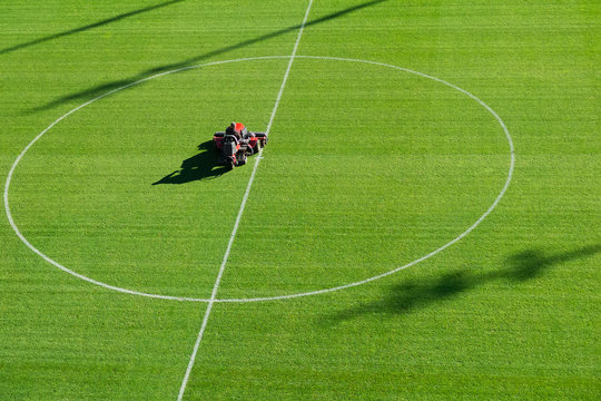 Mowing grass on the football pitch