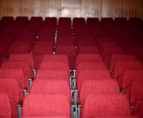 Empty red seats for cinema theater conference or concert