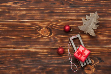 Christmas Decorations. Gift Box On Sleigh. Wooden Background