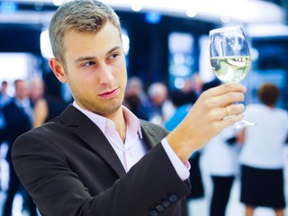 Handsome man tasting wine