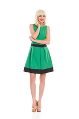 Cheerful blonde girl in green dress