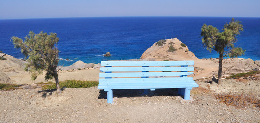 Blue bench on the edge of cliff on Karpathos island, Greece