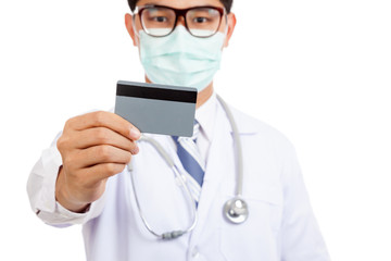 Asian male doctor wear mask with credit card