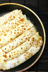 pancakes with jam on a black frying pan