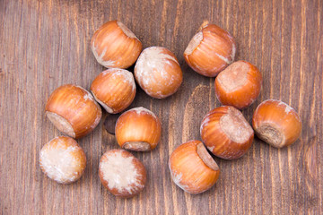 Hazelnuts on wooden table seen from above