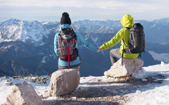 Couple sitting on top of the mountain, looking around, Hallstatt