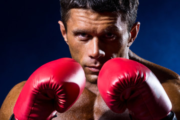 Close-up portrait of boxer in red boxing gloves