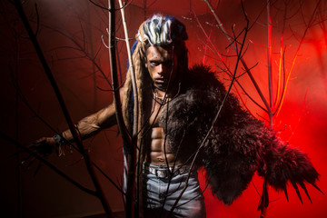 Strong scary werewolf with long nails in the wood.