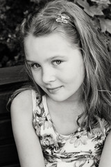 Beautiful young girl is sitting on the bench