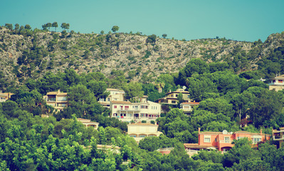 Fototapeta na wymiar Houses in the green mountain hills.