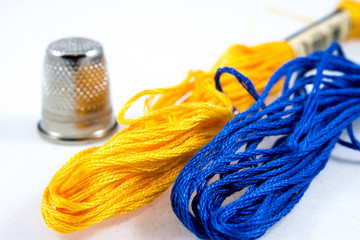 two balls of cotton blue and yellow