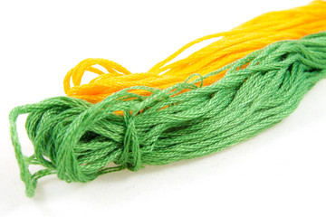 two balls of cotton green and yellow