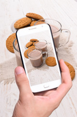 Hands taking photo cocoa with smartphone