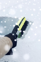 closeup of man cleaning snow from car