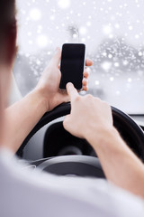 close up of man using smartphone while driving car