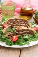 Layered meat pies with green salad