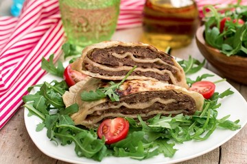Layered meat pies with green salad