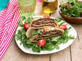 Layered meat pies with green salad