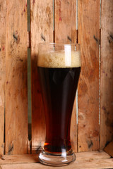 Dark ale in wooden crate