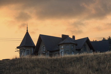 Unfinished building on the hill at sunset