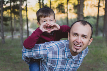 Father and son at autumn walk