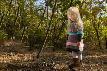 Stylish little blond girl in autumn fashion