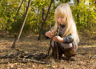 Cute pretty little girl building a wigwam