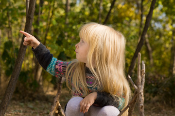 Little blond girl pointing to the side