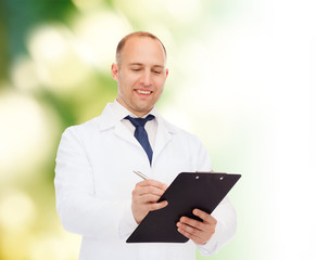 smiling male doctor with clipboard