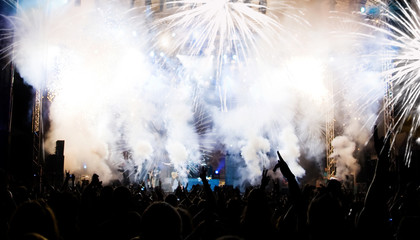 New Year concept - cheering crowd and fireworks