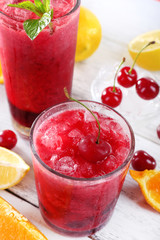 Fresh cold cherry cocktail with mint, ice and lemon